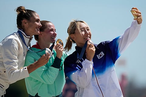 Women's Modern Pentathlon: France's Elodie Clouvel, Hungary's Blanka Guzi, and South Korea Sung Seung-min celebrate their silver, gold and bronze medals